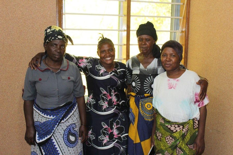 A group of women farmers standing together and smiling