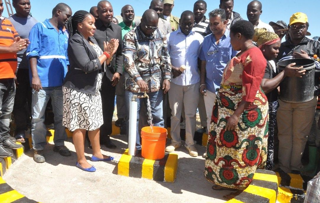 Villagers gather around a new borewell tap