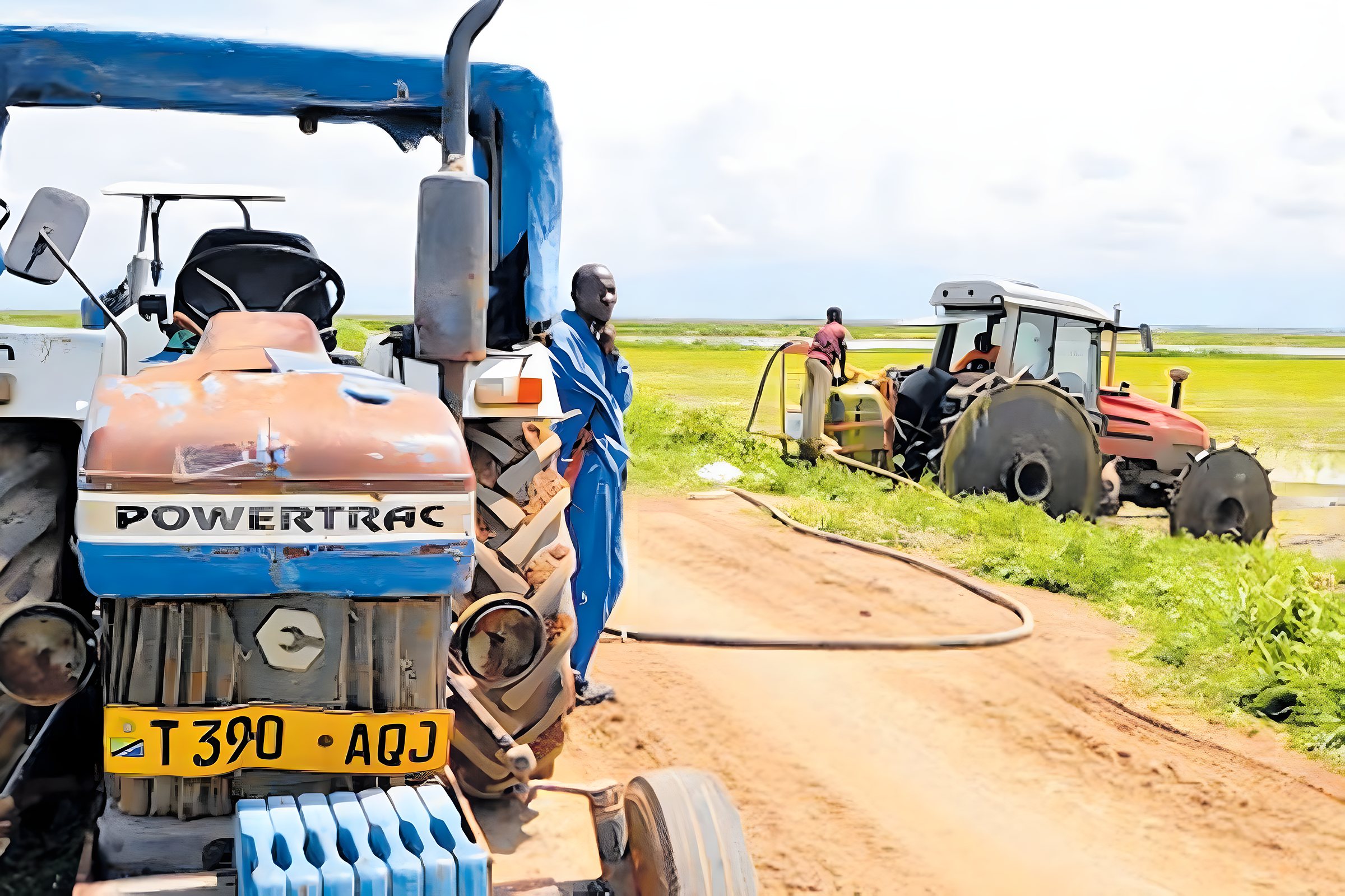 Tractors beside flooded rice paddies